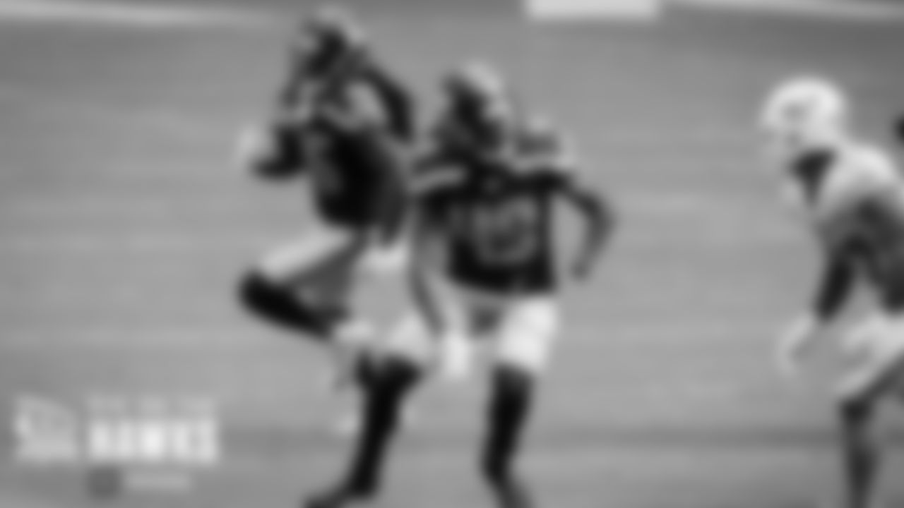Seahawks linebacker Shaquem Griffin looks to make a block as his twin brother, cornerback Shaquill Griffin, returns an interception.