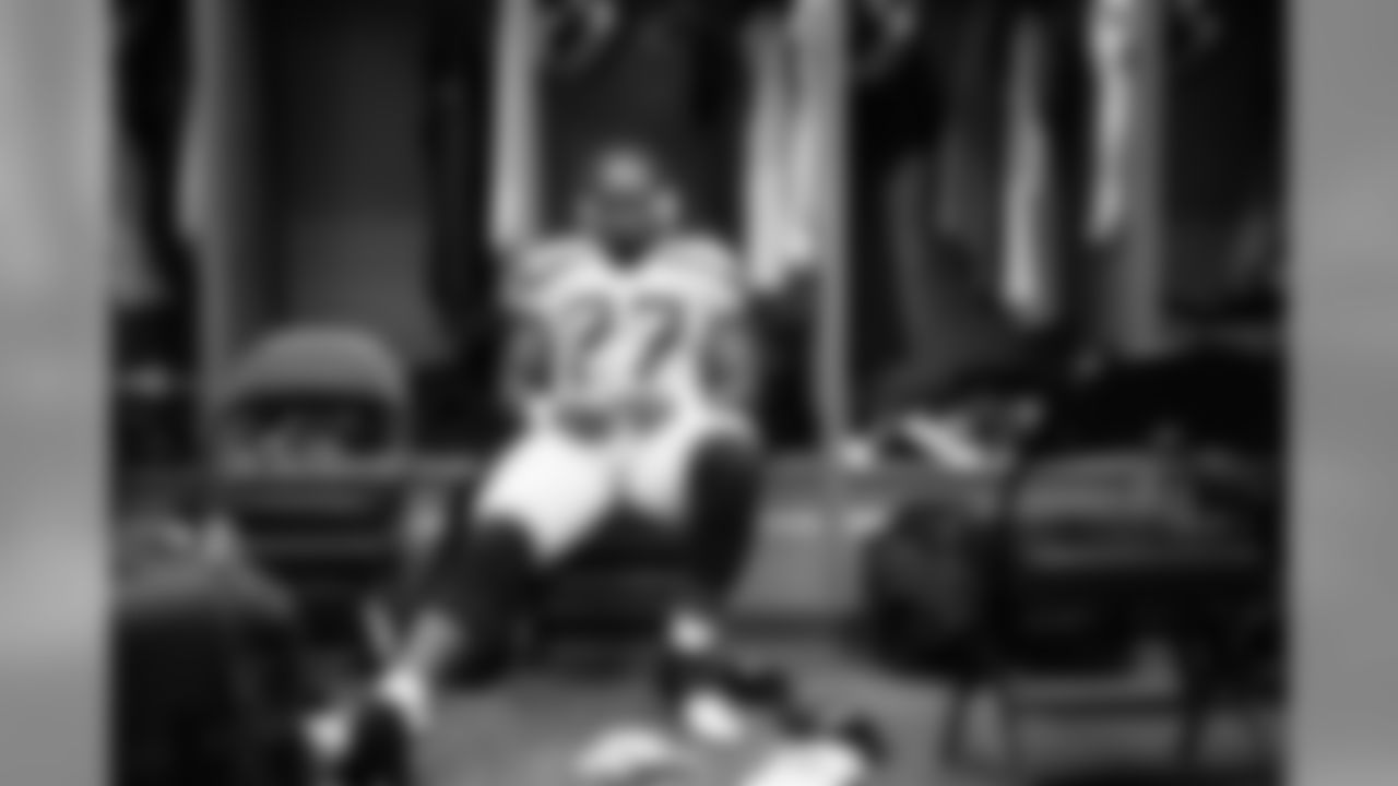 Running back Mike Davis sits at his locker before the game.