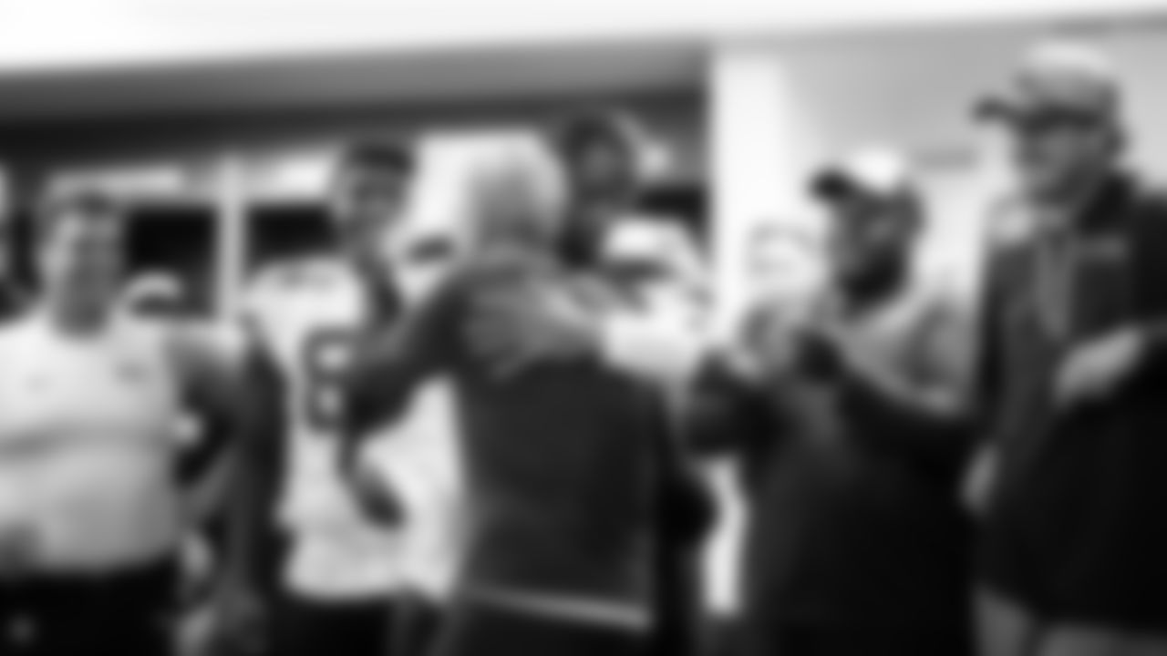 Quarterback Geno Smith hugs head coach Pete Carroll in the locker room after the game.