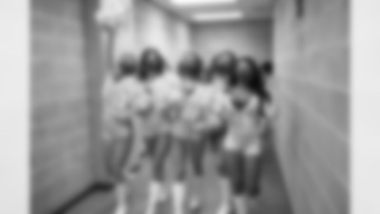 Lillian walking down the hallways of the stadium to the field with her fellow Squad 4 Dancers.