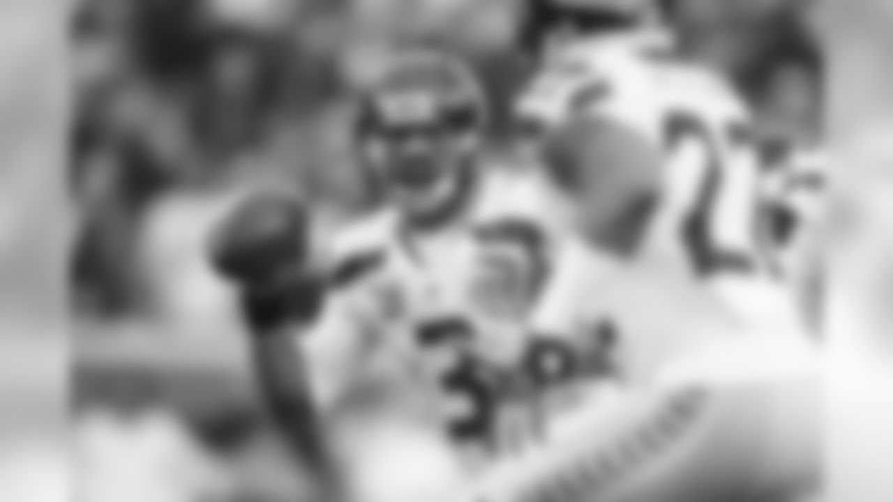 Seattle quarterback Russell Wilson scrambles and sees running back Fred Jackson in the fourth quarter.