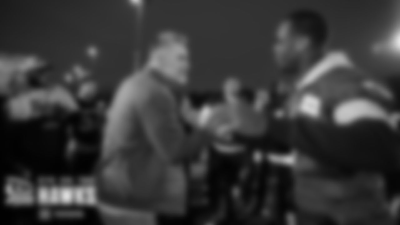 Famed NFL quarterback Kurt Warner greets Seahawks qb Geno Smith after practice.