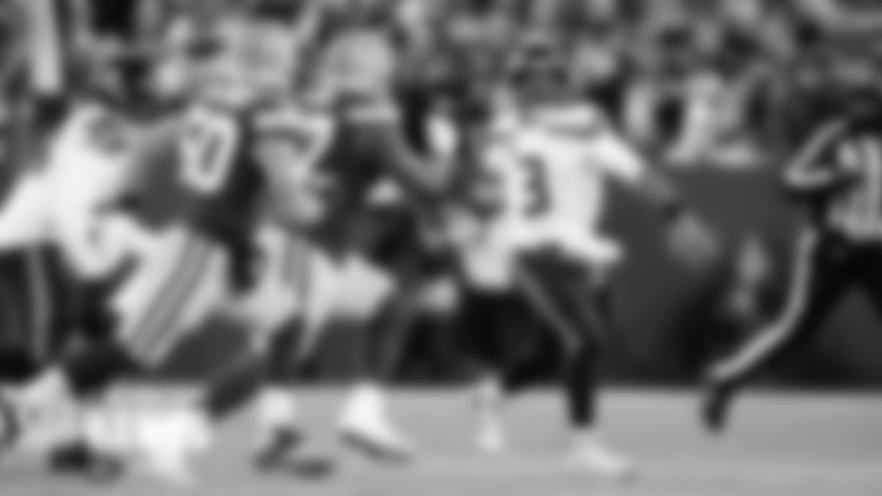 Seahawks quarterback Russell Wilson throws on the run during the first quarter.