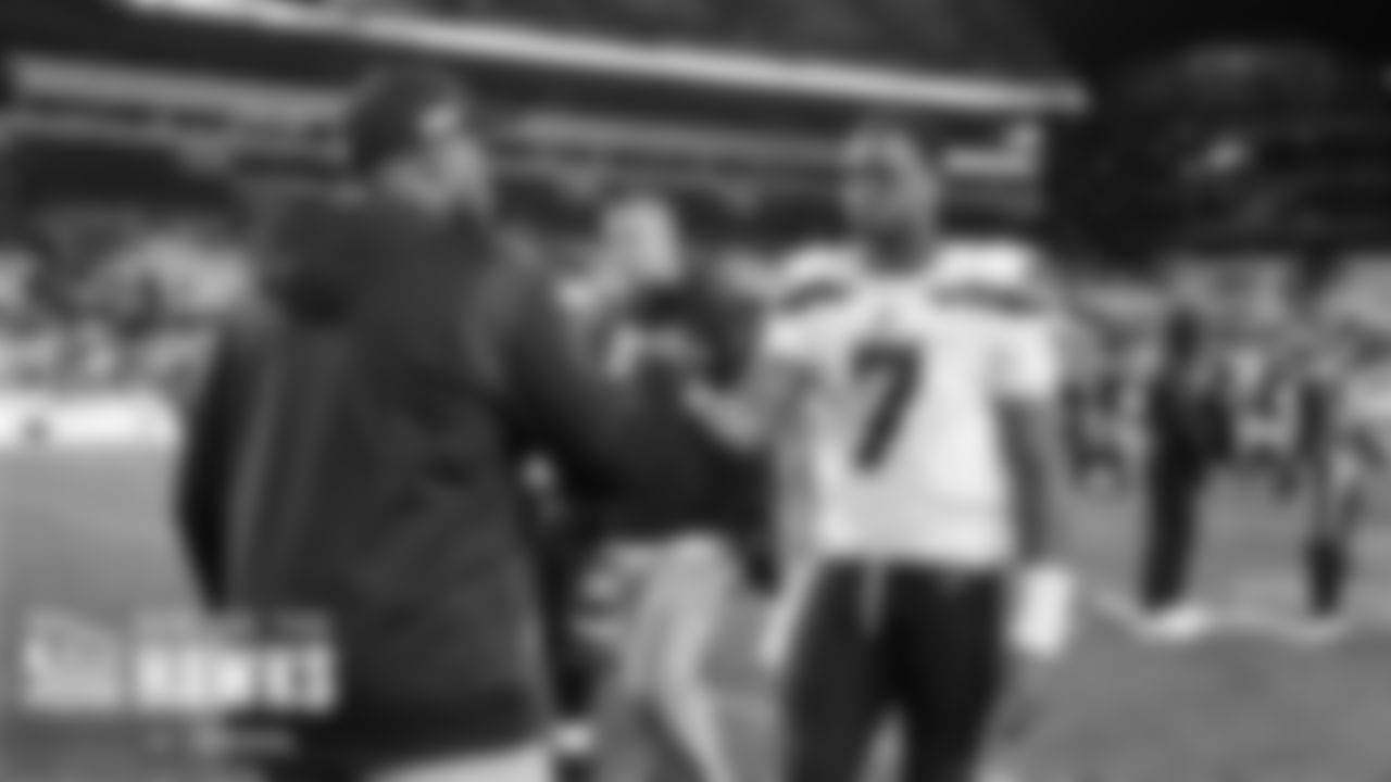 Seahwaks quarterback Geno Smith shakes hands with assistant coach Kerry Joseph after the overtime loss.