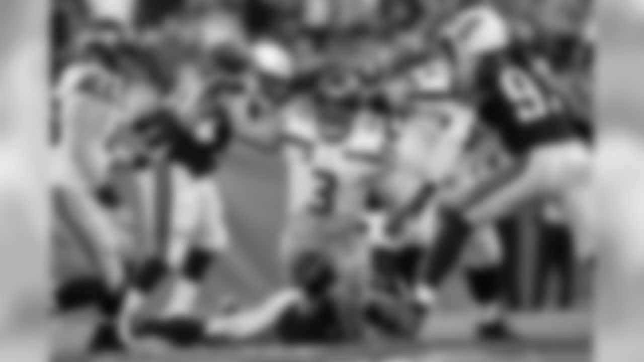 Quarterback Russell Wilson gets rid of the ball as he is brought down in the fourth quarter.