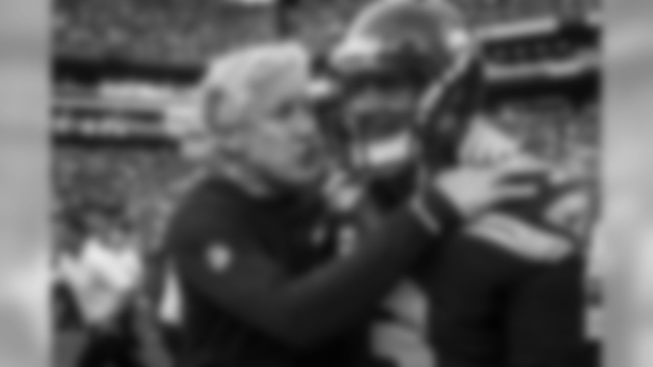 Head coach Pete Carroll celebrates with his quarterback Russell Wilson after the game-winning drive in overtime.