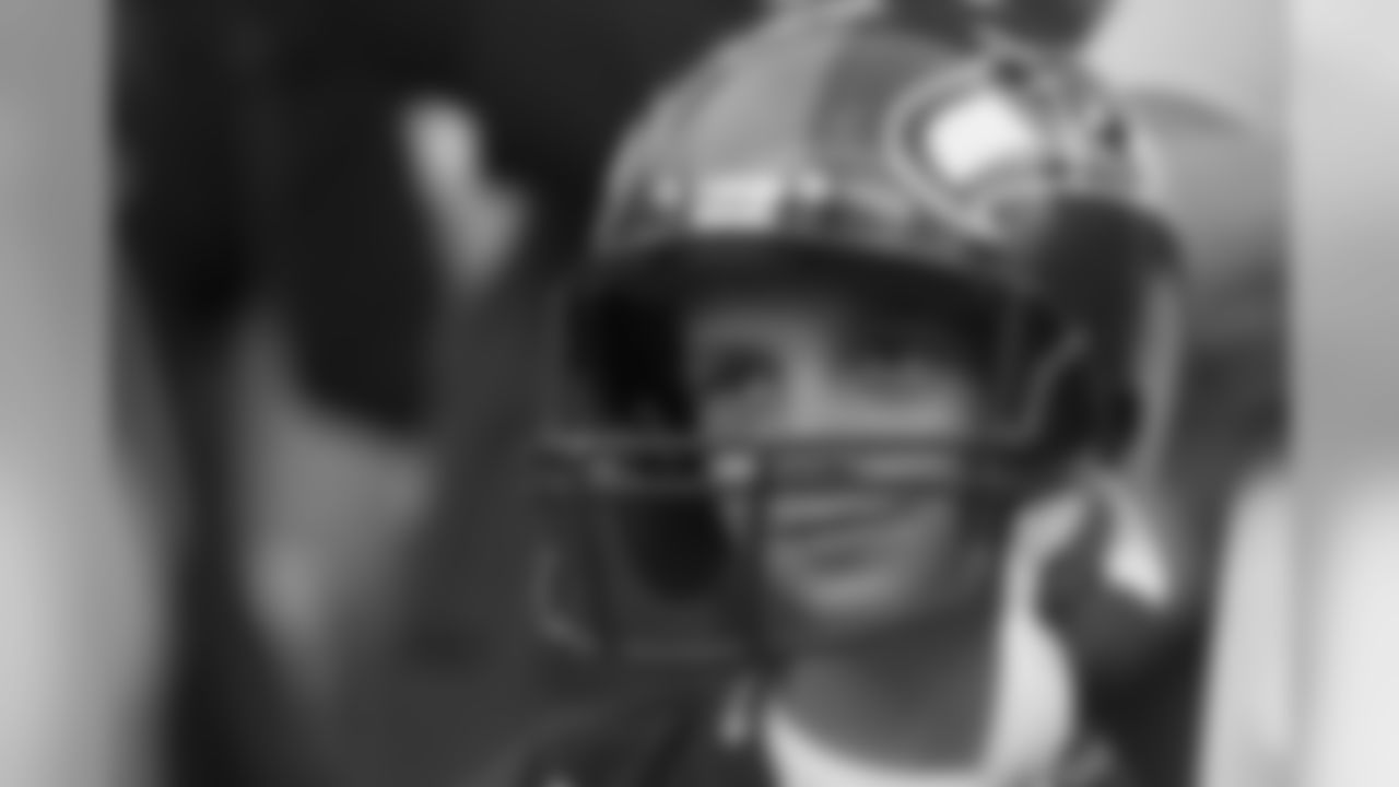 This young fan has yet to grown into his helmet, and seems mesmerized by his seats behind the Seahawks bench.