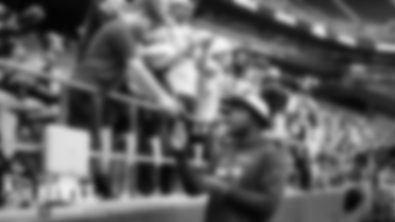 Carlos Dunlap signs autographs before the game.