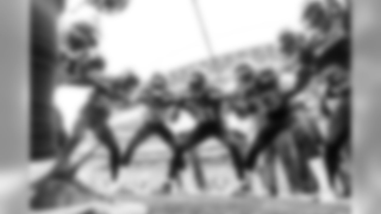 The defensive backs get pumped in their pregame circle.