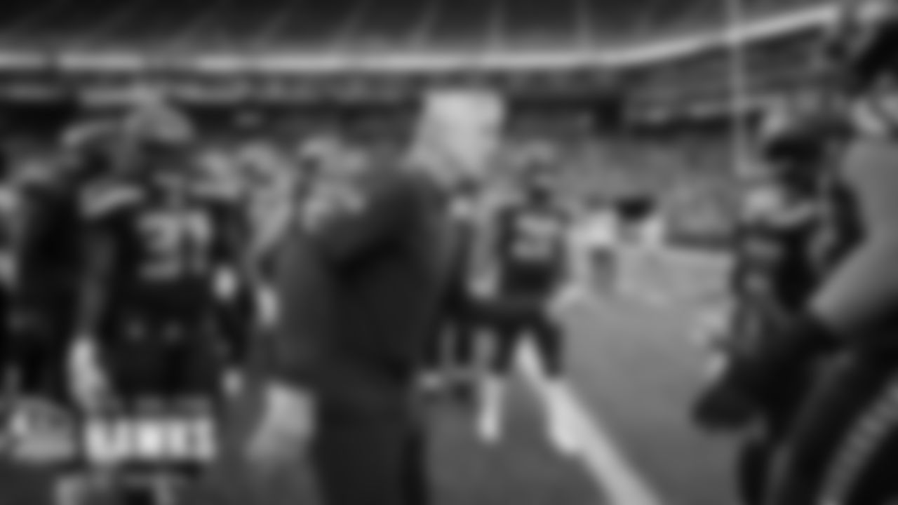 Head coach Pete Carroll greets players as they come onto the field for pregame warmups.