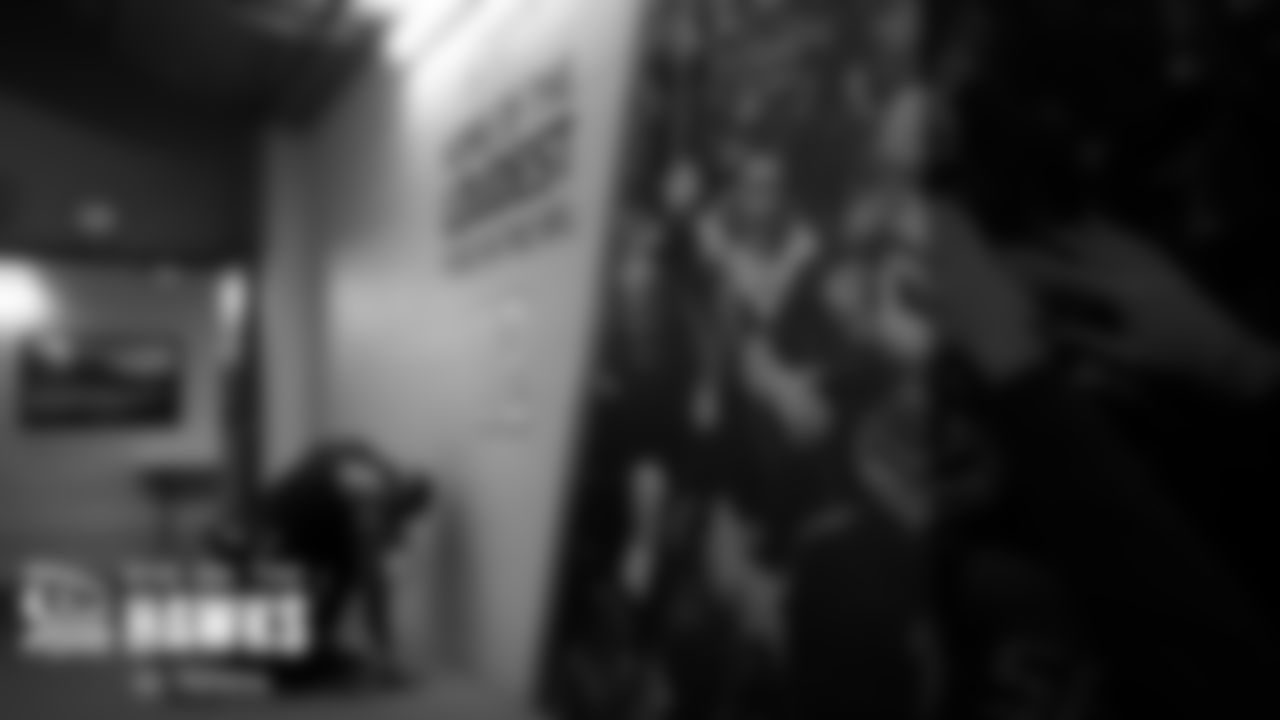 Seahawks safety Jamal Adams kneels in prayer outside of the locker room before the game.