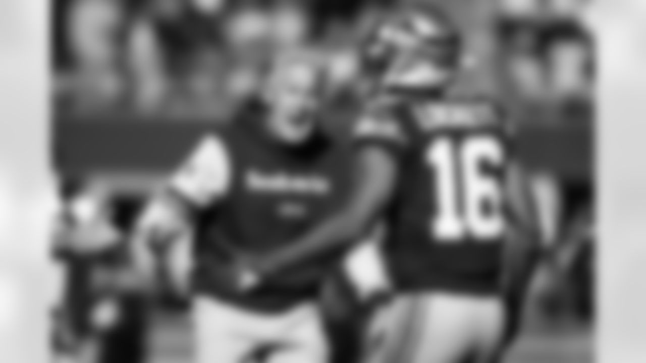 Seahawks head coach Pete Carroll celebrates a play with receiver Tyler Lockett.