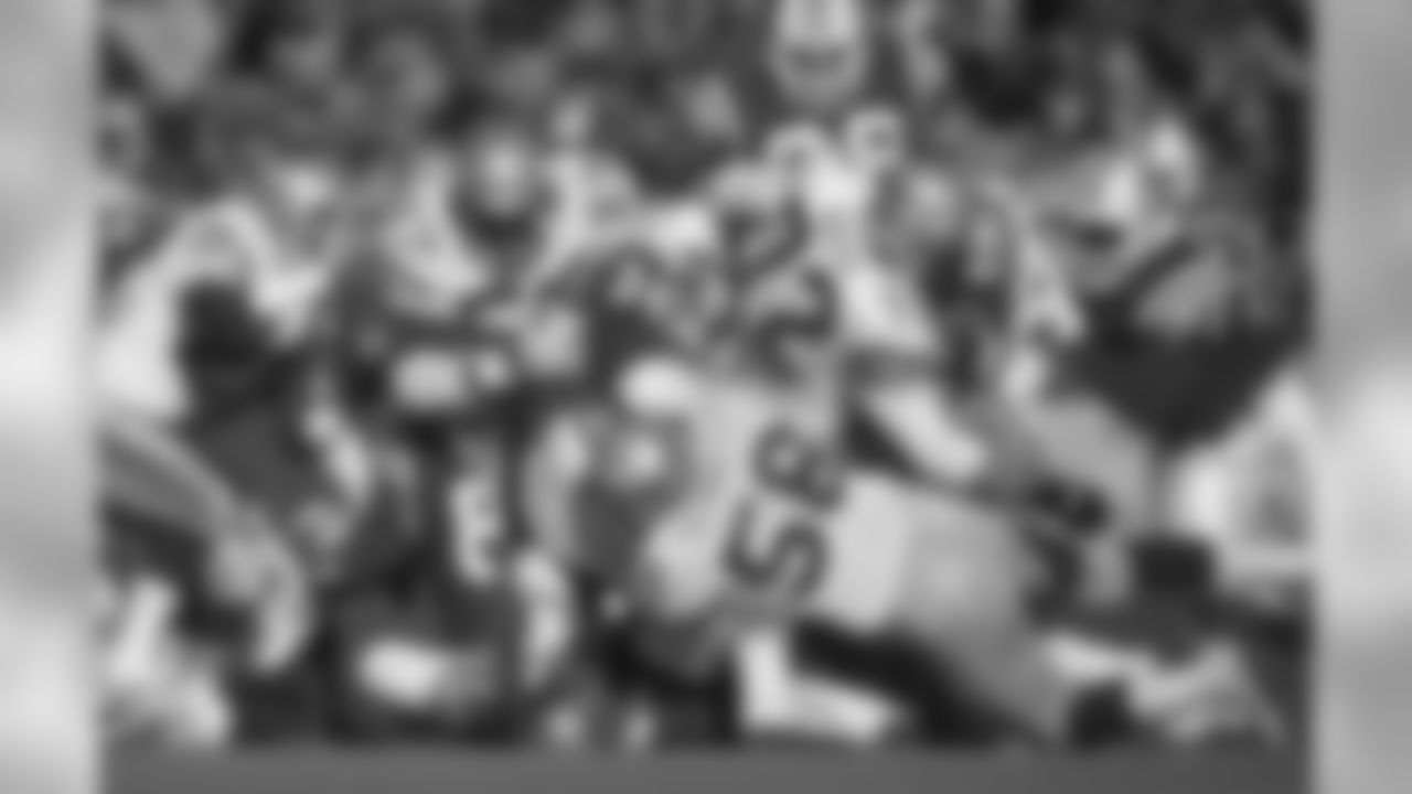 Seattle Seahawks linebackers Bruce Schultz (58) and Tony Woods (57) and nose tackle Joe Nash (72) team up to stop New England Patriots fullback Bob Perryman (34) during an NFL game in Foxboro, Mass., Dec. 4, 1988. The Patriots defeated the Seahawks 13-7. (AP Photo/Damian Strohmeyer)