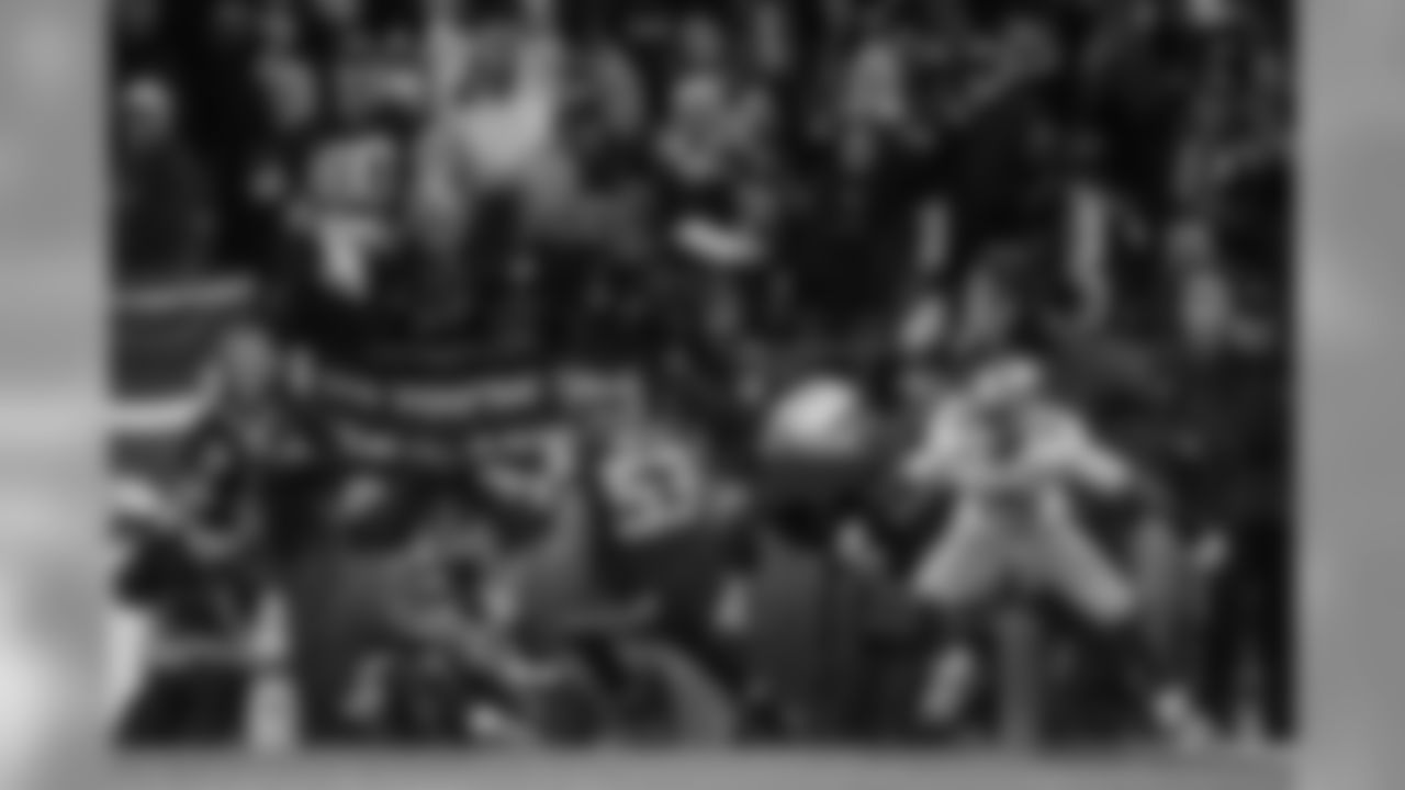 As the crowd erupts, linebacker Malcolm Smith cradles the pass tipped by teammate Richard Sherman in front of Michael Crabtree sealing the victory, the NFC Championship and a trip to the Super Bowl.