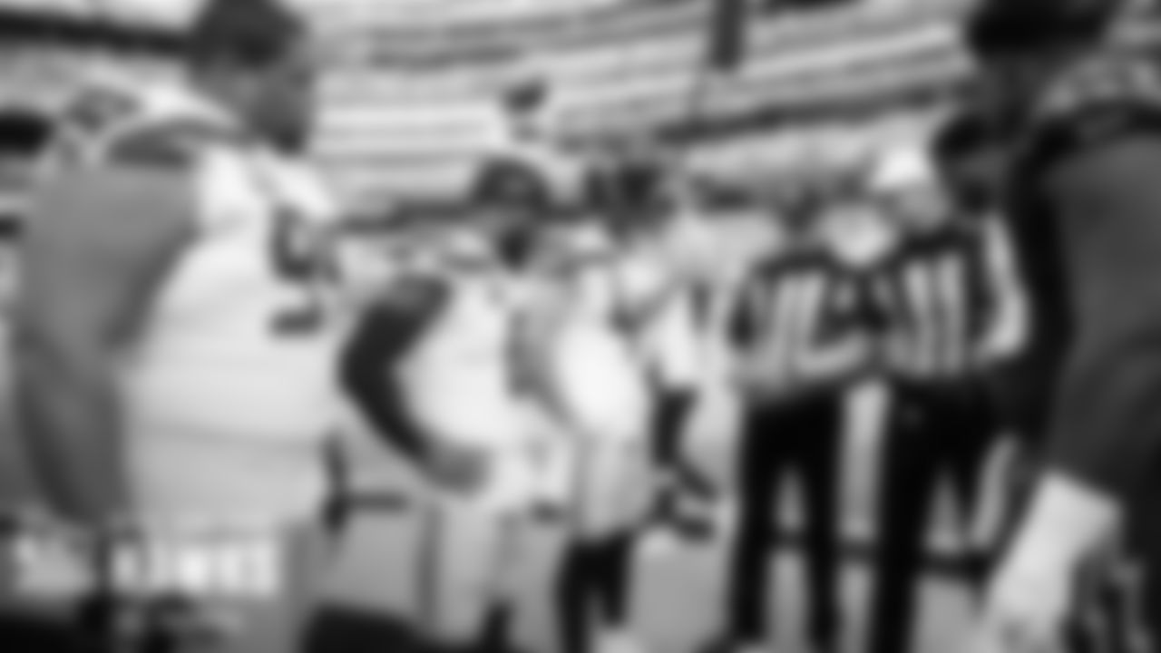 Captains Al Woods, Quandre Diggs and Nick Bellore meeting with officials and the Cardinals captains for the coin toss.