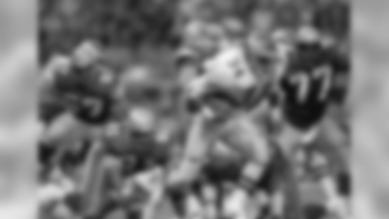 Herschel Walker (34) of the Philadelphia Eagles tries to avoid Tyrone Rodgers (91) and Jeff Bryant (77) of he Seattle Seahawks during the fourth quarter of their NFL game in Seattle, Dec. 14, 1992. (AP Photo/Bill Chan)