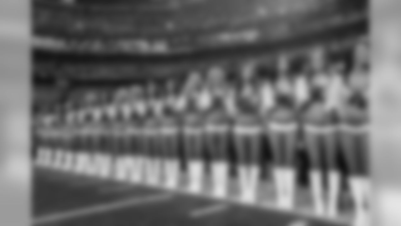 The Sea Gals stand at attention during the singing of the National Anthem.