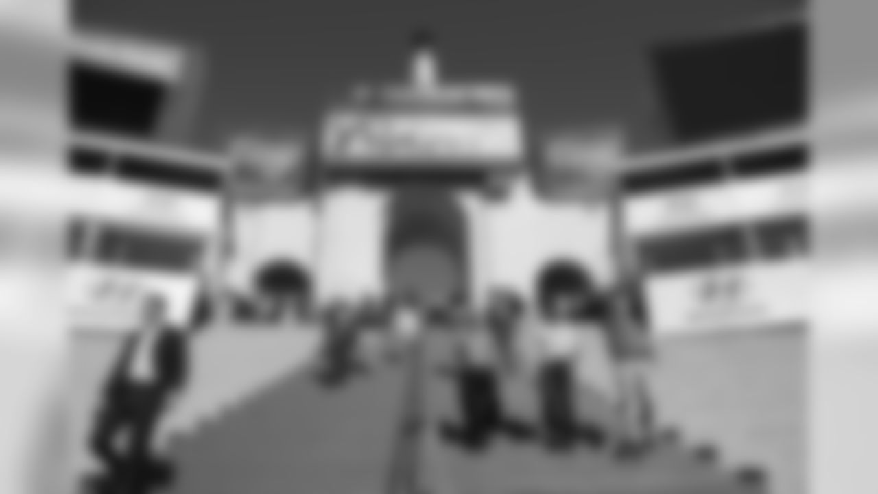 Players and coaches descend the grand steps at the L.A. Coliseum during a brief visit on Saturday afternoon.