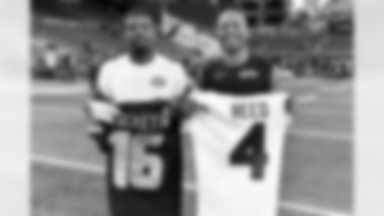 Seattle Seahawks wide receiver Tyler Lockett (16) and New York Jets cornerback D.J. Reed (4) swap jerseys after an NFL football game on Sunday, January 1, 2023 in Seattle, Washington. (Alika Jenner/NFL)