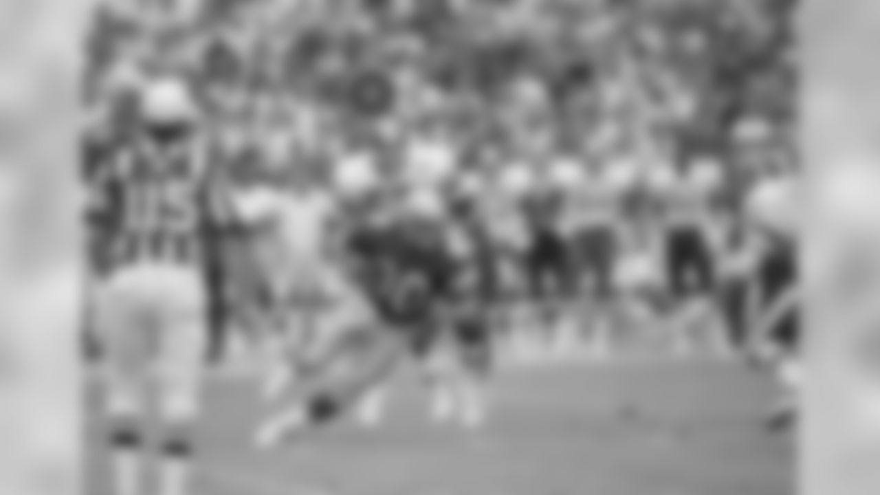 Seattle Seahawks receiver Steve Largent (80) comes down with a catch, to tie the NFL record of 127 consecutive games with a reception as Redskins linebacker Rich Milot (57) tries to bring him down in the first half of their game in Washington, Sept. 28, 1986. Largent tied Harold Carmichael's record with this catch near the end of the first half. (AP Photo/Tom Reed)