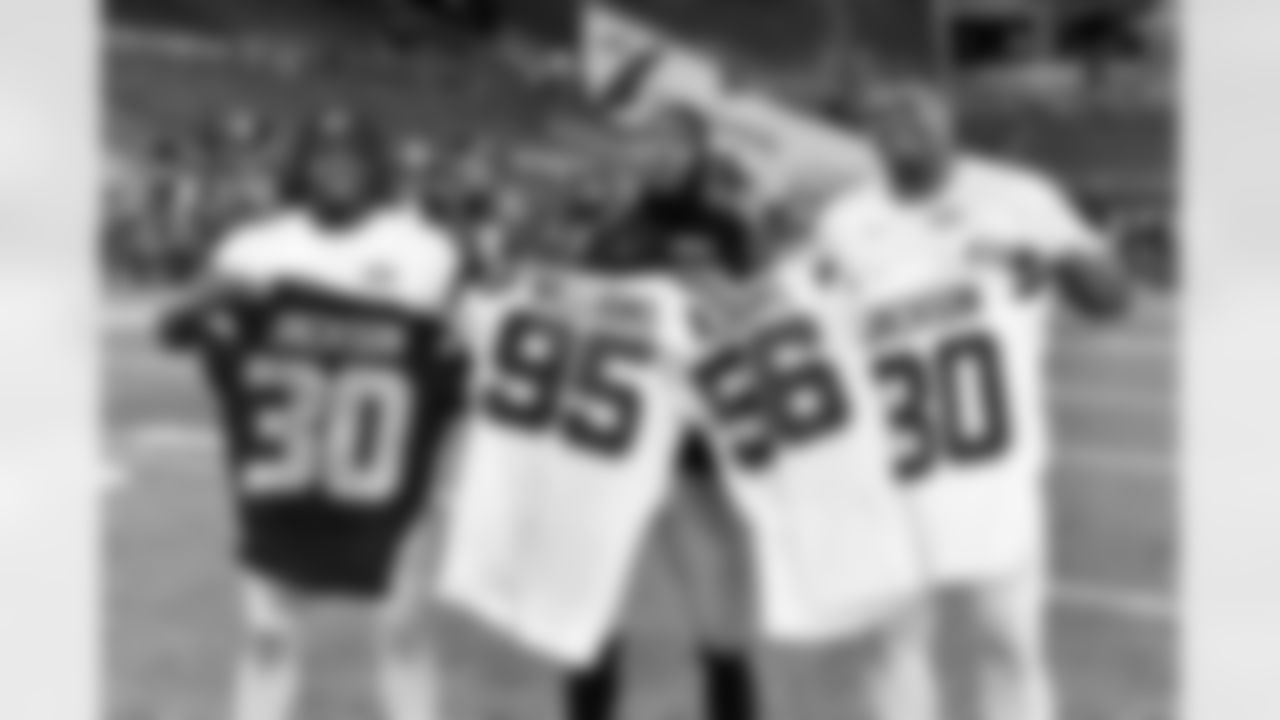 Seattle Seahawks cornerback Mike Jackson (30), New York Jets defensive tackle Quinnen Williams (95) , New York Jets linebacker Quincy Williams (56) andNew York Jets cornerback Michael Carter II swap jersey after an NFL football game on Sunday, January 1, 2023 in Seattle, Washington. (Alika Jenner/NFL)