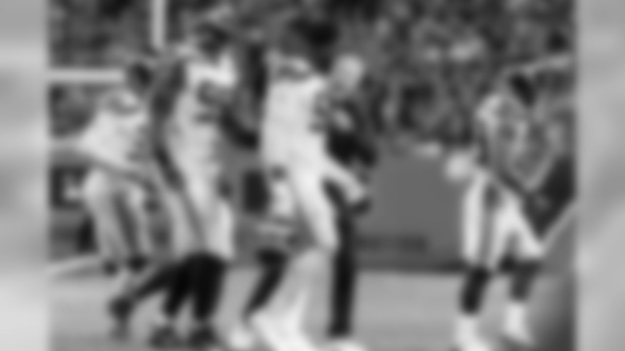 Head coach Pete Carroll congratulates defensive end Frank Clark after the defense forced Chicago to punt.