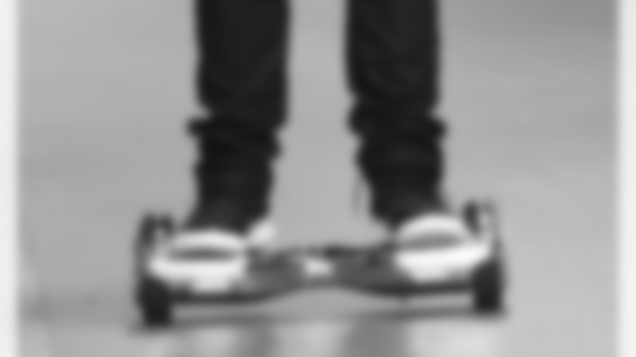 Seattle Seahawks wide receiver B.J. Daniels rides an electric self-balancing scooter commonly called a "hoverboard," as he arrives for an NFL football game against the Carolina Panthers, Sunday, Oct. 18, 2015, in Seattle. (AP Photo/Stephen Brashear)