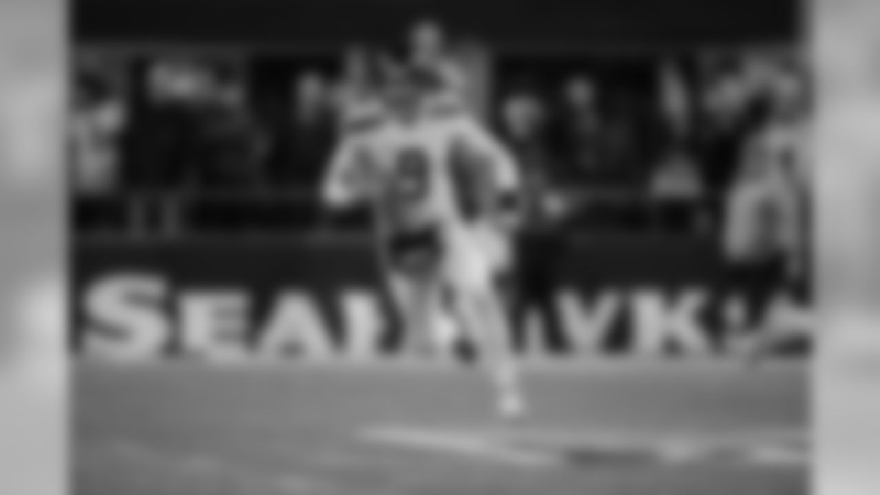Jon Ryan runs the ball up the field on a fake punt in the fourth quarter.