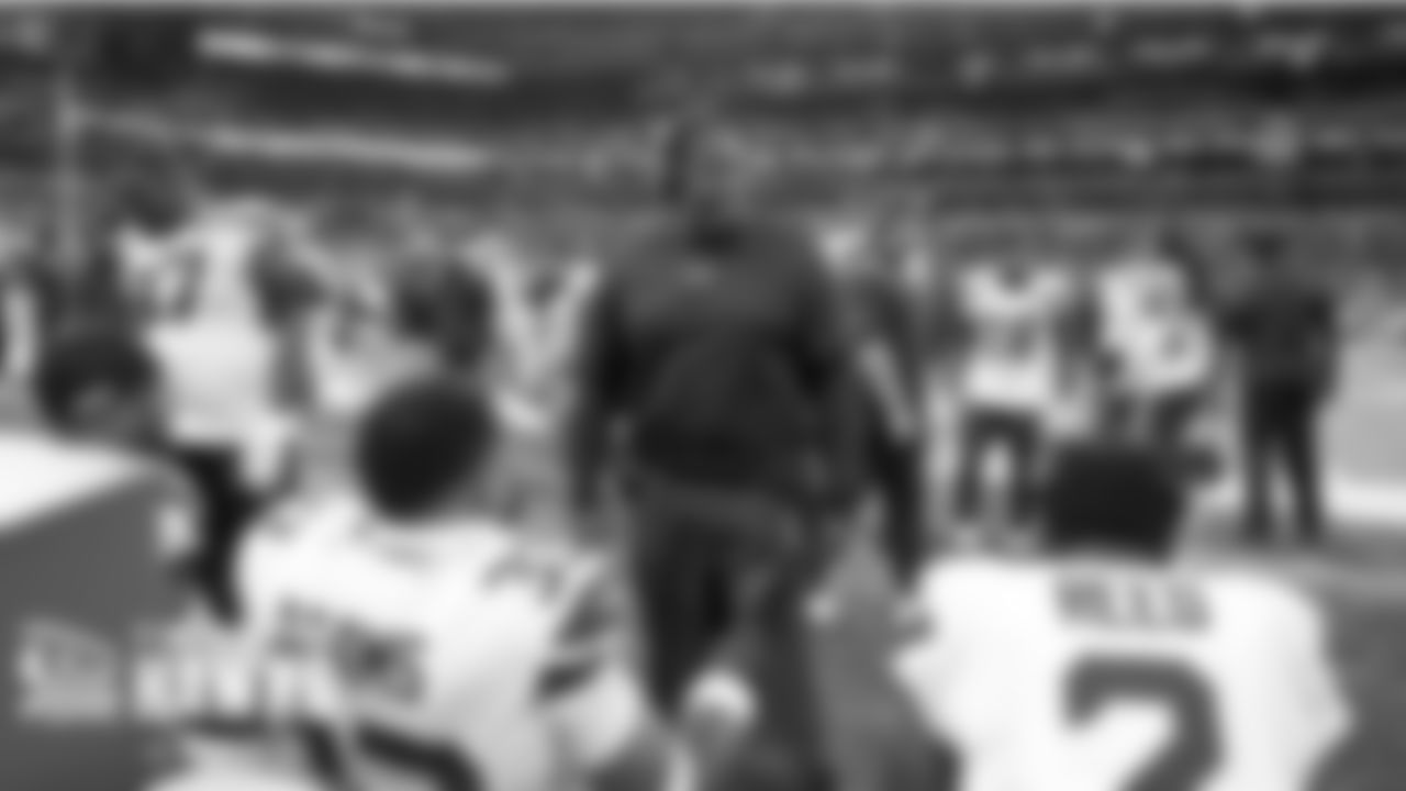 Seahawks defensive backs coach Andre Curtis smiles on the sidelines with players Ugo Amadi, Jamal Adams and D.J. Reed near the end of the game.