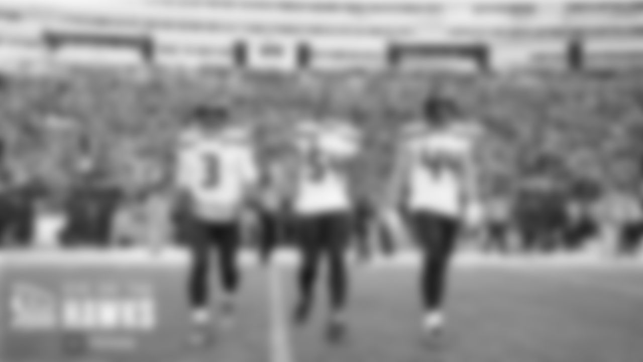 Seahawks captains Russell Wilson, Bobby Wagner and Nick Bellore head to midfield for the opening coin toss.