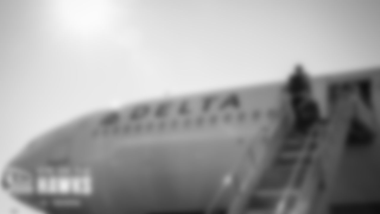 Seahawks players and coaches board the team charter for the flight to Miami.