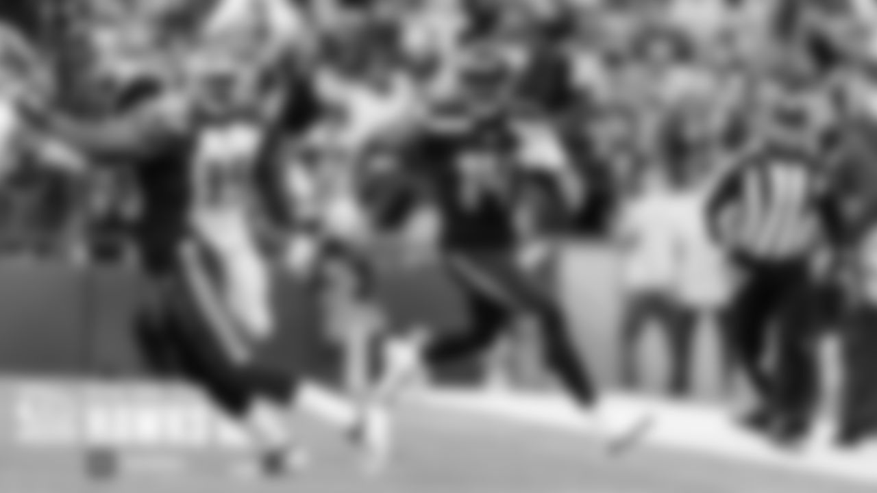 Seahawks receiver DK Metcalf gains yards as teammate David Moore blocks.