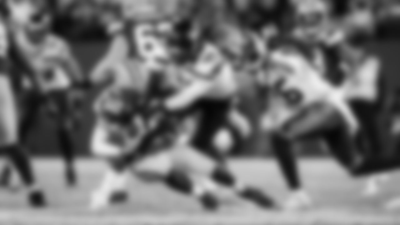 Seahawks defenders Shaquem and Shaquill Griffin bring down Green Bay quarterback Aaron Rodgers in the fourth quarter.