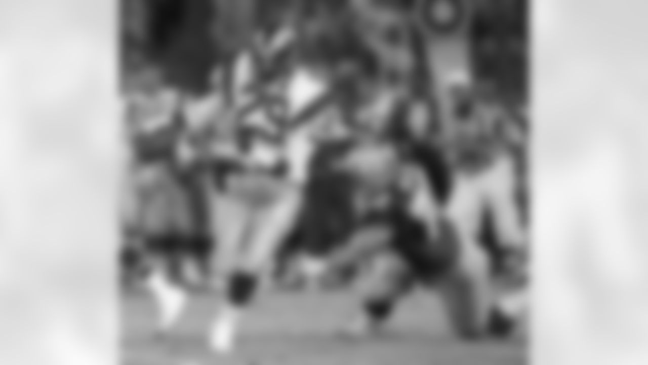 FILE - In this Aug. 13, 1987, file photo, Los Angeles Rams running back Eric Dickerson (29) breaks away from Seattle Seahawks' Joe Nash during an NFL preseason football game in Anaheim, Calif. On Tuesday, Aug. 29, 2017, Dickerson signed a one-day contract to retire as a member of the L Rams, reuniting the famous running back with his first NFL football franchise. Dickerson also became a vice president of business development with the Rams, who returned to Los Angeles last year after 21 seasons in St. Louis. (AP Photo/Lennox McLendon, File)