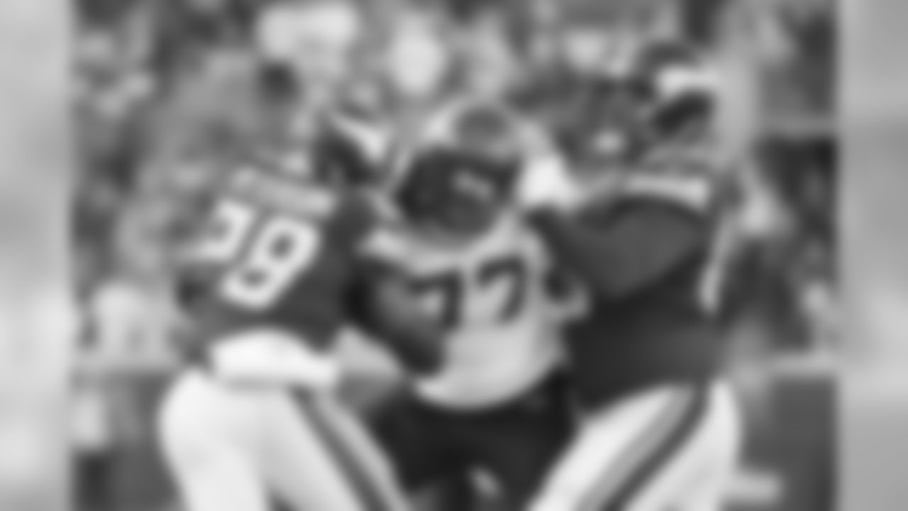 The Vikings sought to establish their running game with the league's leading rusher in Adrian Peterson, but Seahawks defensive end Michael Bennett fought off a block with one hand while tackling Peterson with the other on this stop in the first quarter.