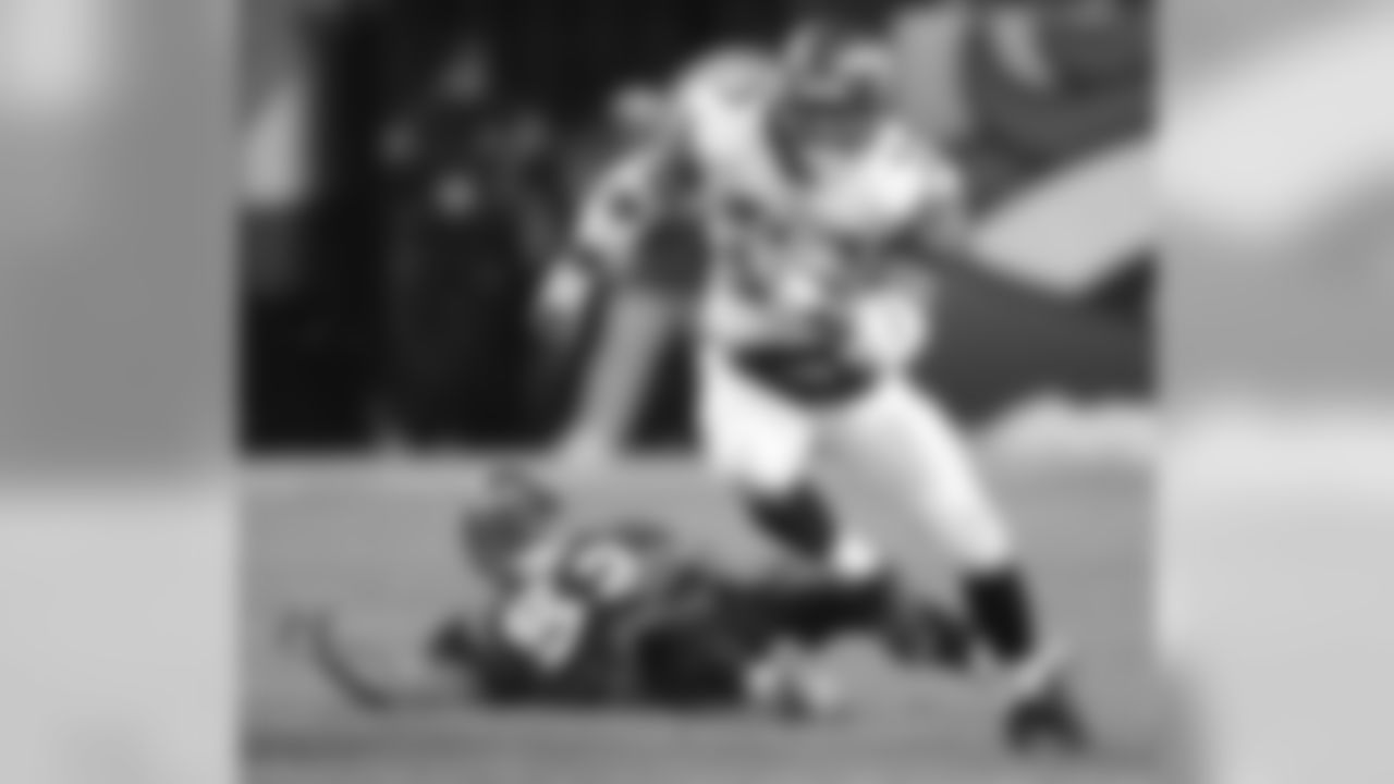 Seattle Seahawks running back Shaun Alexander (37) breaks a tackle attempt by Denver Broncos linebacker Ian Gold (52) during a football game in Denver, Sunday, Dec. 3, 2006. Seattle beat Denver 23-20. (AP Photo/Jack Dempsey)