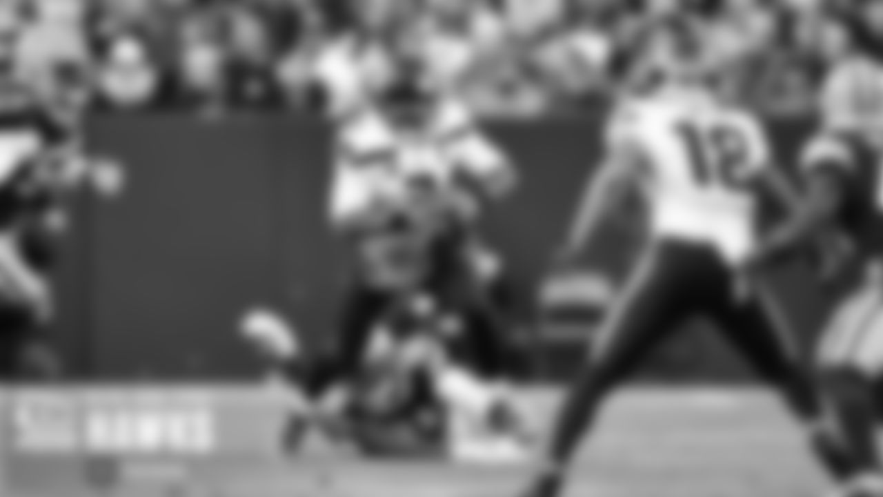 Seahawks quarterback Russell Wilson escapes the pocket and a near-sack.