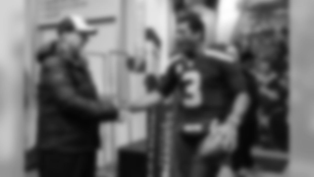 Seahawks owner Paul Allen greets a happy Russel Wilson in the locker room after the victory.
