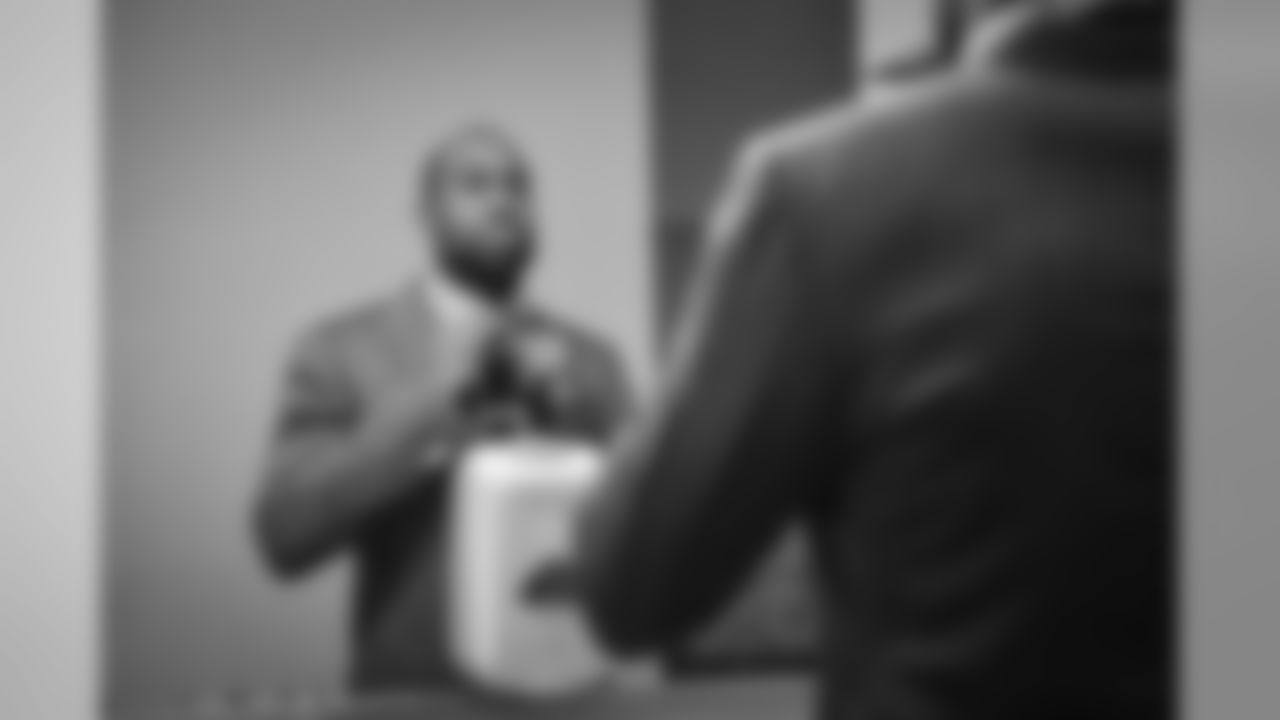 Seahawks cornerback Brandon Browner puts the finishing touches on his necktie as the team dressed up for the relatively short flight to Arizona.