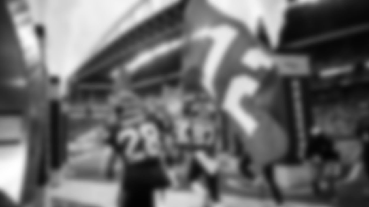 Ugo Amadi carries the 12 flag out of the tunnel as the Seahawks are introduced.