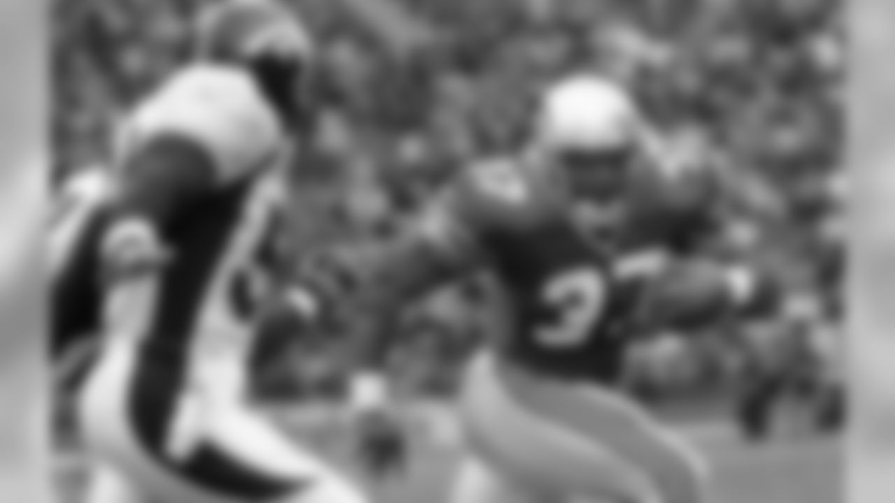 Seattle Seahawks' Shaun Alexander (37) heads past Denver Broncos' Lee Woodall for a second-quarter touchdown run Sunday, Oct. 14, 2001, in Seattle. (AP Photo/Elaine Thompson)