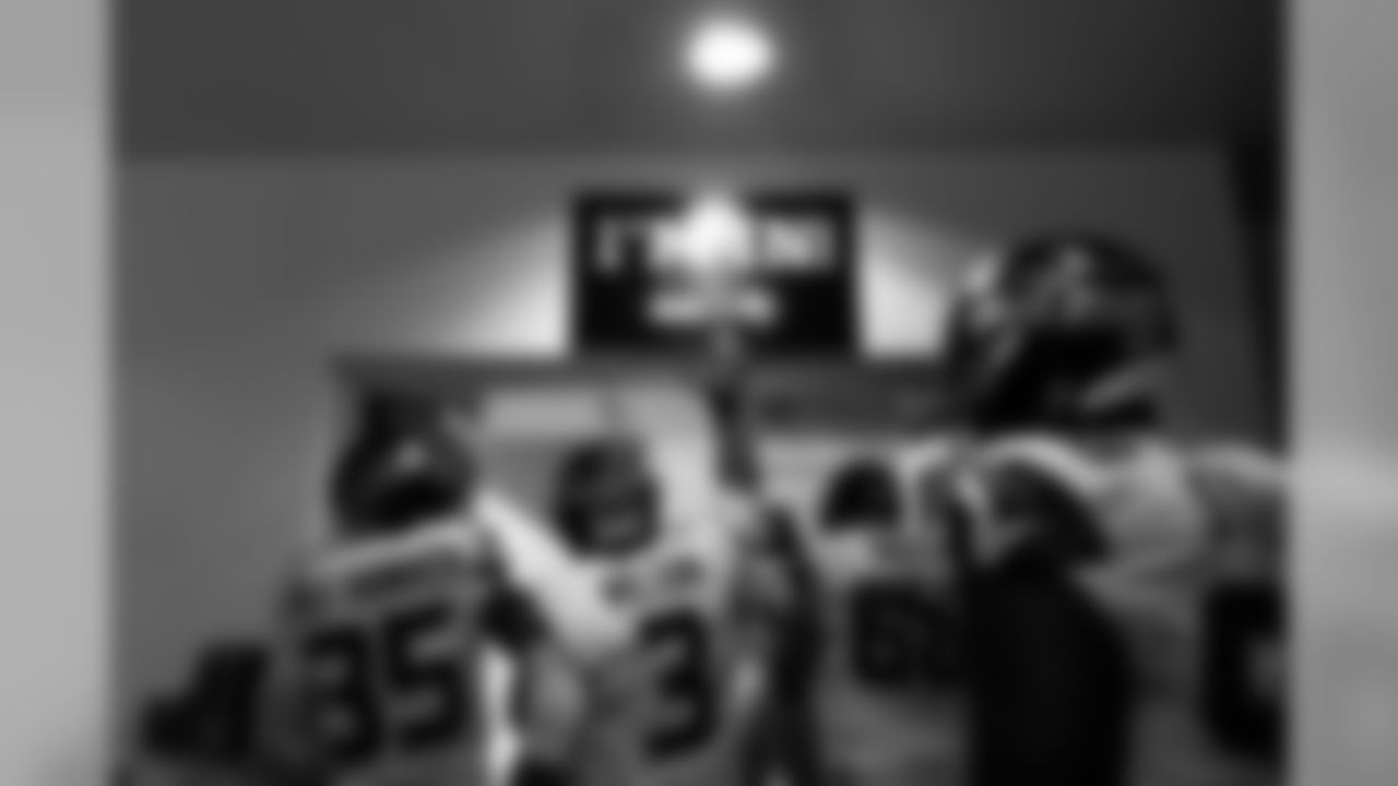 Russell Wilson and teammates "tap in" before heading to the field for kickoff.