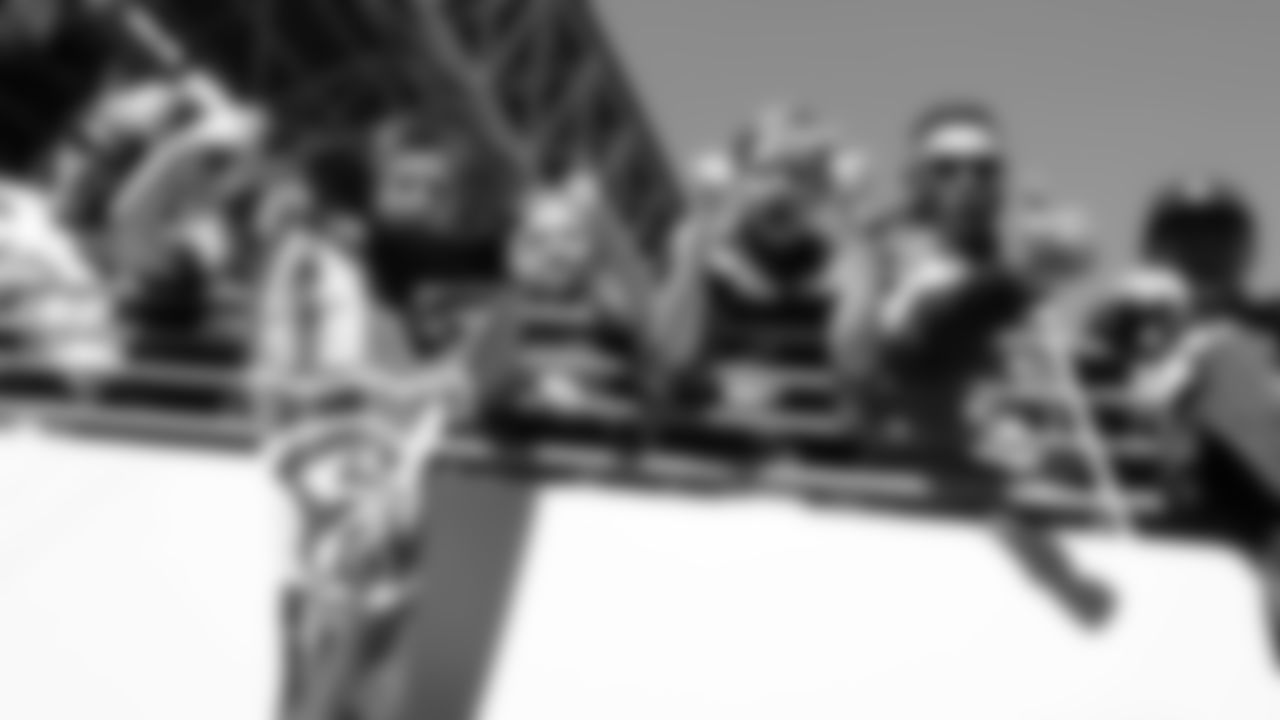 Fans along the railing near the Seahawks tunnel cheer the players as they enter the field.