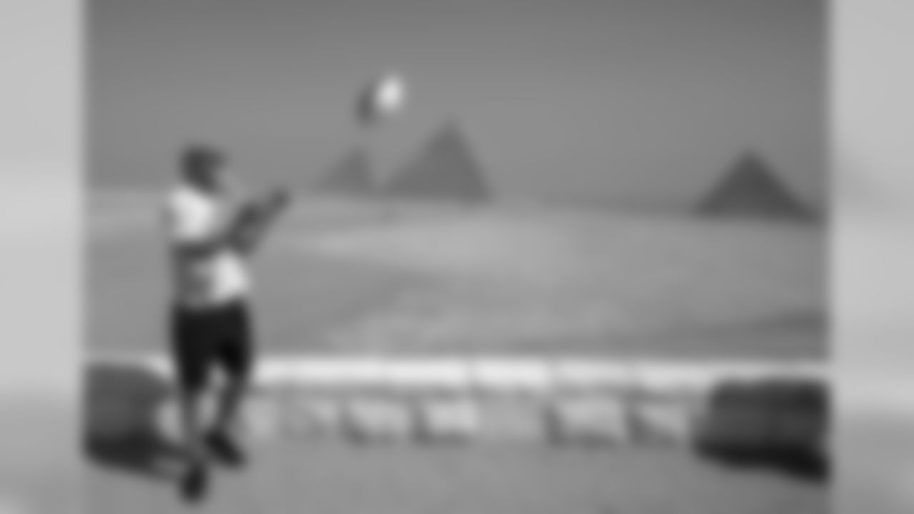 In this Monday, Feb. 29, 2016 photo, Quarterback player, Colby Cameron of the Fujitsu Frontiers, visits the Pyramids of Giza, in Cairo, Egypt. The players are on a visit to Egypt with American Football Without Barriers, a non-profit organization that educates disadvantaged children in the United States and overseas. In conjunction with the Egyptian Federation of American Football, AFWB will have free camps basic, junior and advanced levels for players ages 14-25, as well as a coaching clinic led by Breno Giacomini. (AP Photo/Roger Anis)