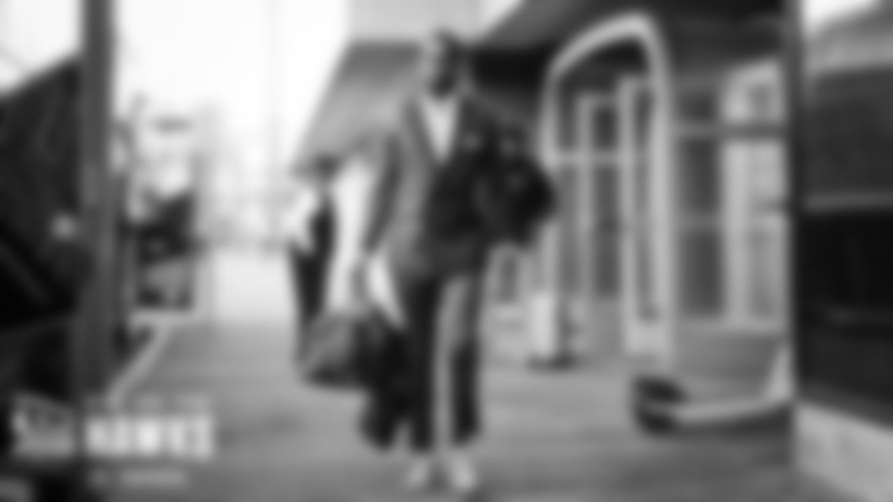 Quarterback Geno Smith walks to the buses.