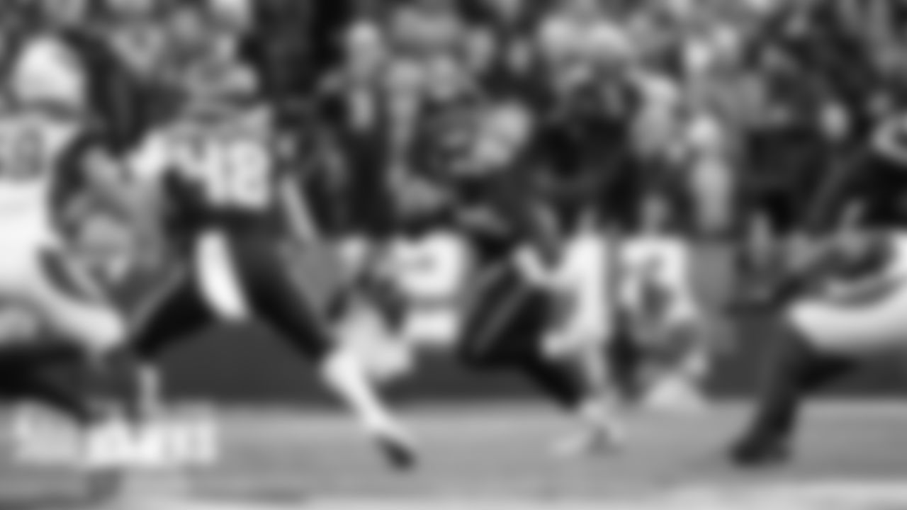 Seahawks quarterback Russell Wilson rolls out and looks for receivers.
