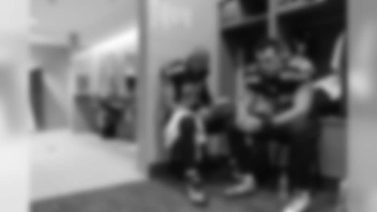 Tight end Jimmy Graham reviews game notes as he and Luke Willson sit together in the final moments before the team is set to leave the locker room to face the Jets.