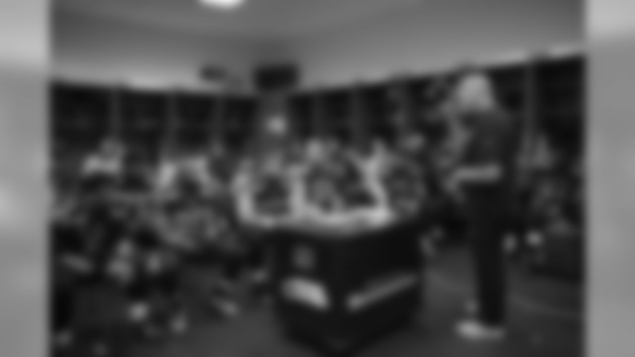 At halftime, assistant head coach Tom Cable addresses the offense.