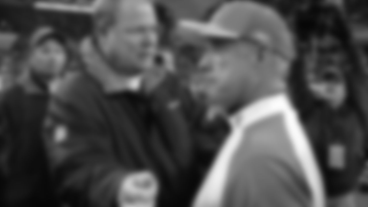 Seattle Seahawks coach Mike Holmgren, left, greets Miami Dolphins interim coach Jim Bates after their game Sunday, Nov. 21, 2004, in Seattle. The Seahawks won, 24-17. (AP Photo/Elaine Thompson)