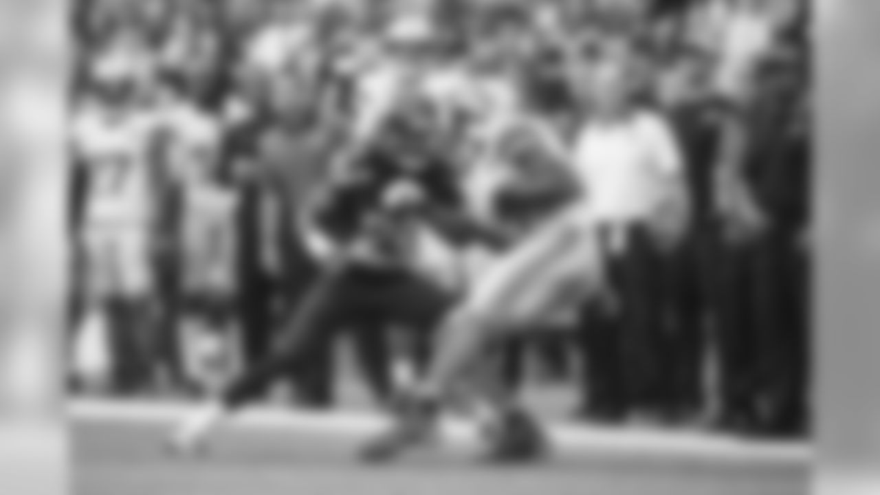 Cornerback Richard Sherman keeps his eyes on his target as he tackles Detroit's Calvin Johnson along the Lions sideline.
